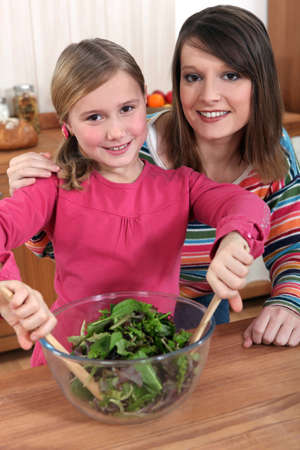 mother and daughter making a saladの写真素材