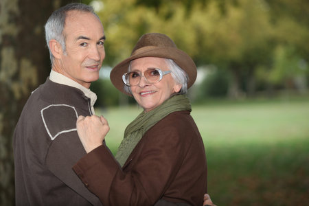 A mature couple in a park.