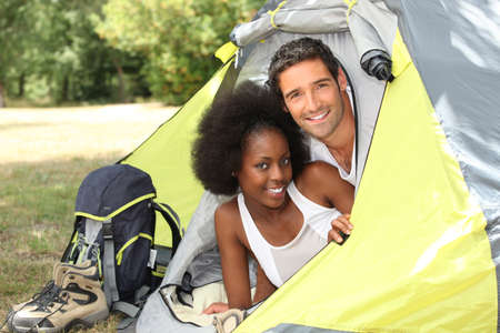 Couple with tent on camp siteの写真素材