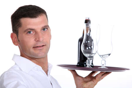 Waiter serving a bottle of beerの写真素材