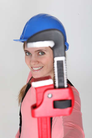 Pipe wrench jaw framing a womanの写真素材