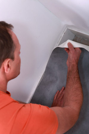 Man putting down linoleum flooring