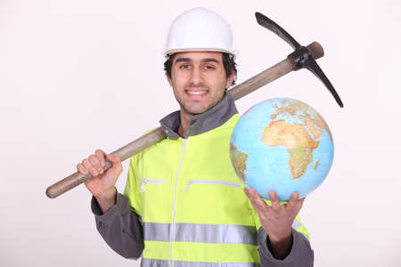 Construction worker holding a glove and pickaxeの写真素材