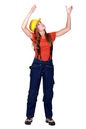 A female construction worker repositioning something.の写真素材