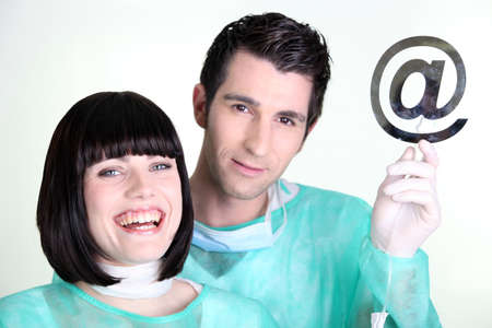 Doctors holding up the at symbolの写真素材