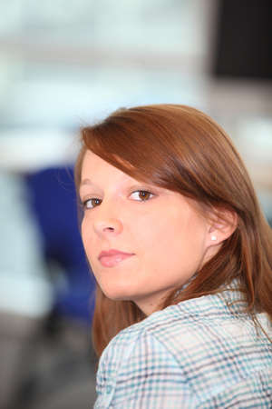 Young woman looking over her shoulderの写真素材