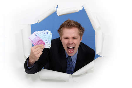 A businessman with plenty of cash.の写真素材