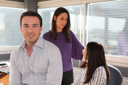 Relaxed man sitting in an officeの写真素材