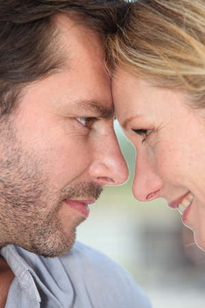 Couple with heads togetherの写真素材