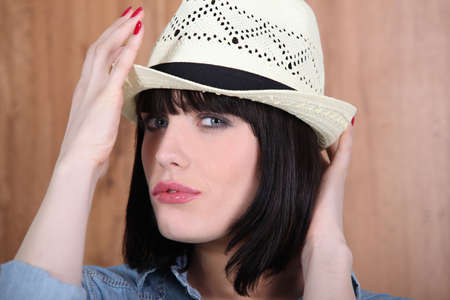 Woman adjusting her hatの写真素材