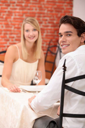 cute young couple at restaurantの写真素材