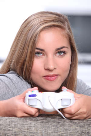 Teenage girl playing on games consoleの写真素材