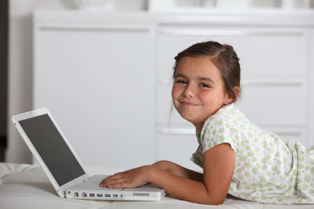 Young girl using a laptop computerの写真素材