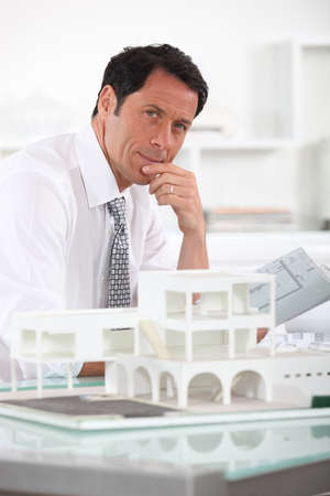 Architect with plans and 3D modelの写真素材