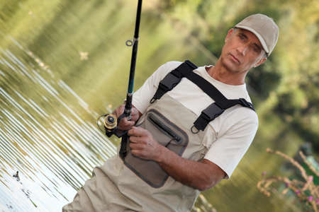 Man fishing in lakeの写真素材