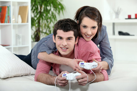 A couple of teenager playing video game.