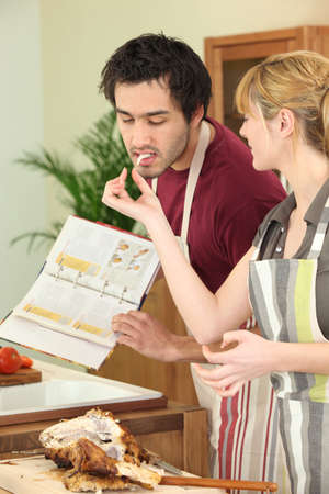 young couple cooking togetherの写真素材