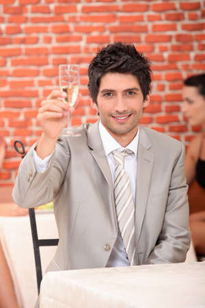 Man raising glass of champagneの写真素材
