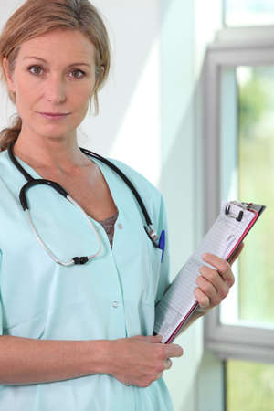 Female doctor with stethoscope and clipboardの写真素材