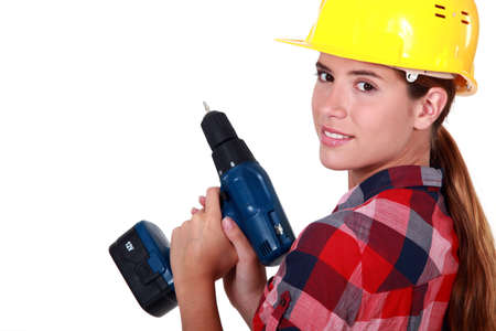 A female construction worker holding a drill.の写真素材