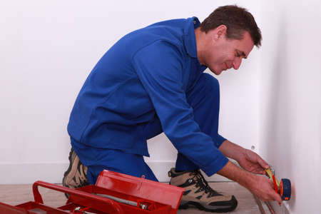 Plumber measuring pipe workの写真素材