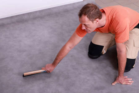 Man renovating the floorの写真素材