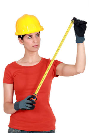 craftswoman holding a meterの写真素材