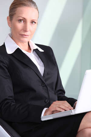 Anxious businesswoman with laptop.の写真素材