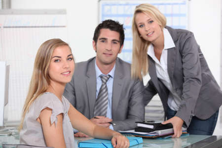 Three colleagues in officeの写真素材