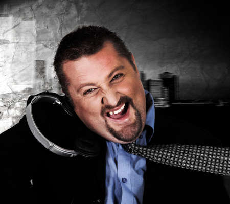 Crazy man in suit with headphonesの写真素材