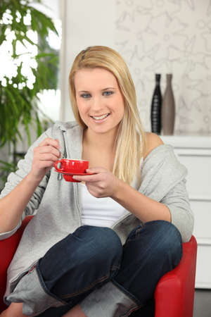 Young woman having a cup of coffee at homeの写真素材