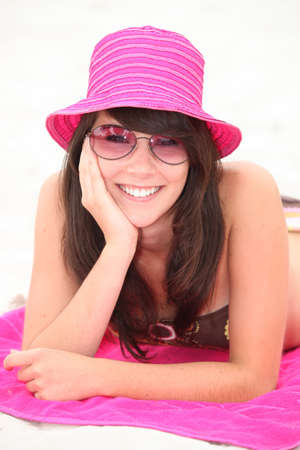 Female teenage laid on towelの写真素材