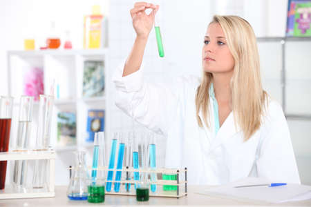 Female chemistry student with a test tubeの写真素材