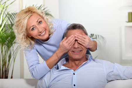 wife covering her husbandの写真素材