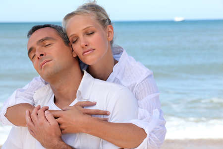Couple standing on secluded beachの写真素材