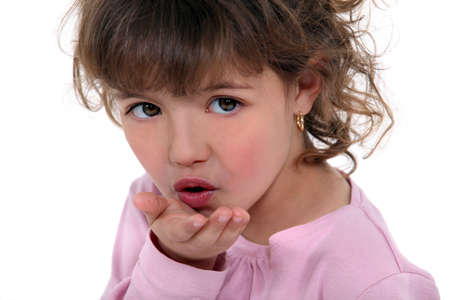 Little girl blowing kissの写真素材