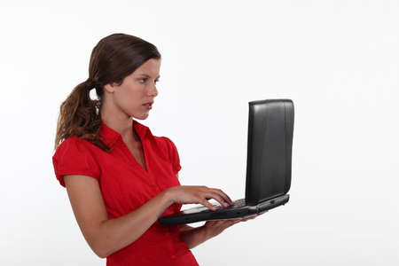 Woman standing and typing.の写真素材