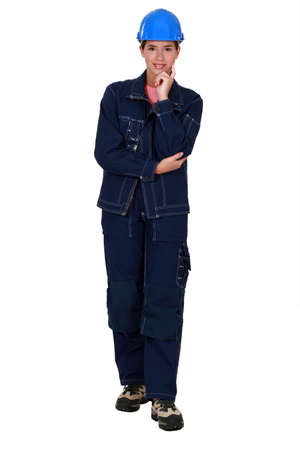 Female plumber standing on white backgroundの写真素材