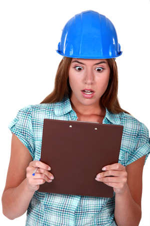 Woman surprised in front of a notepadの写真素材