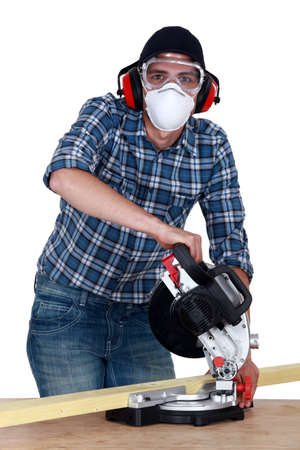 A carpenter with a circular saw.の写真素材