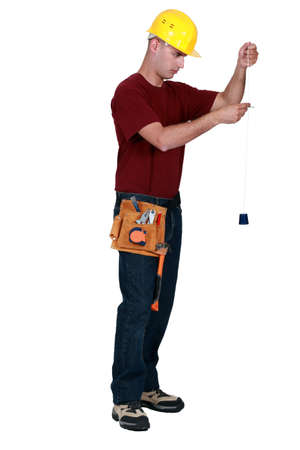 Builder with a plumb lineの写真素材