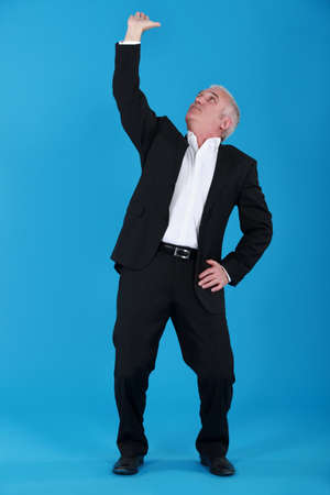 Businessman pushing ceilingの写真素材