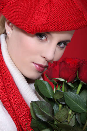 portrait of gorgeous blonde with red roses and assorted clothesの写真素材