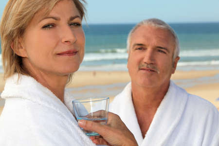 Couple wearing matching robes outdoorsの写真素材