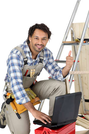 Happy laborer using computerの写真素材