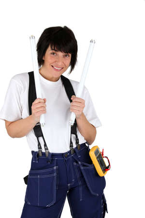 Female electrician with lightbulbsの写真素材