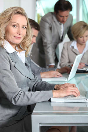 Businesswoman on laptop smilingの写真素材