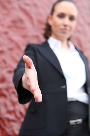 Young woman reaching out the hand for handshakingの写真素材