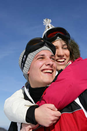 Young couple laughing on the ski slopesの写真素材