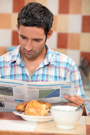 guy having breakfastの写真素材